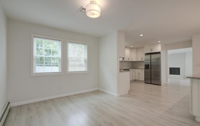 Empty room, Interior, Kitchen, Recessed Lighting, Stainless Steel Appliances, Wood Texture Flooring