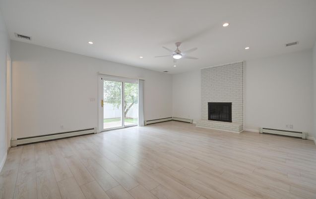Empty room, Fireplace, Interior, Recessed Lighting, Stone Walls, Wood Texture Flooring