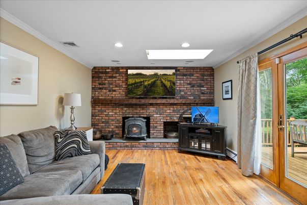 Fireplace, Interior, Living room, Recessed Lighting, Stone Walls, Wood Texture Flooring