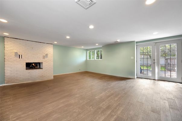 Empty room, Fireplace, Interior, Recessed Lighting, Stone Walls, Wood Texture Flooring