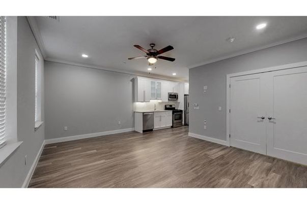 Empty room, Interior, Kitchen, Recessed Lighting, Stainless Steel Appliances, Wood Texture Flooring