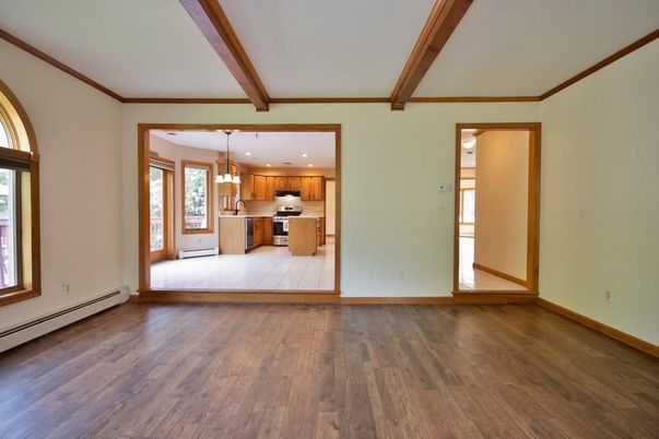 Empty room, Interior, Kitchen, Pendant Lights, Recessed Lighting, Stainless Steel Appliances, Wooden Beams, Wood Texture Flooring