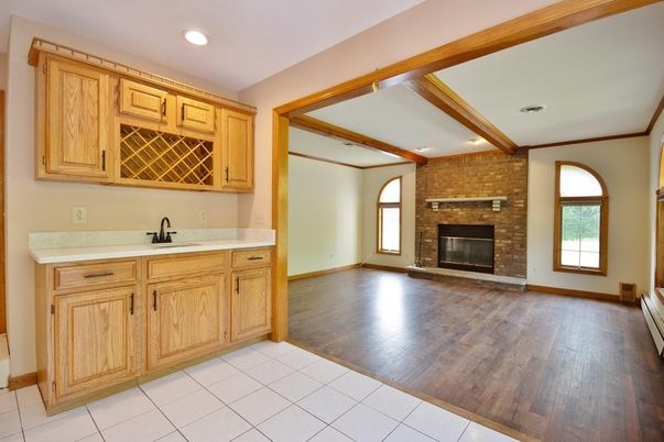 Empty room, Fireplace, Interior, Kitchen, Recessed Lighting, Stone Walls, Wood Texture Flooring