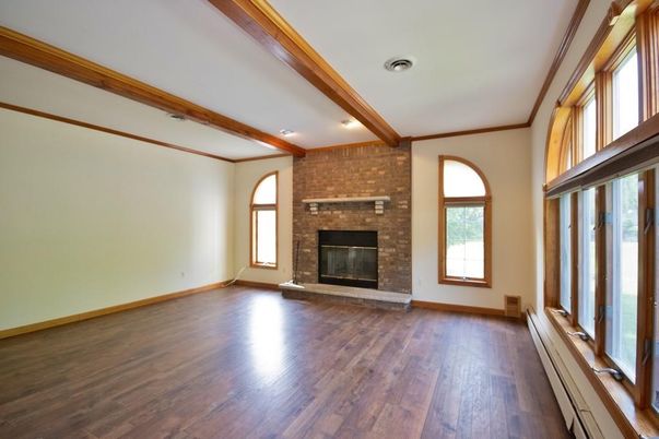 Empty room, Fireplace, Interior, Recessed Lighting, Stone Walls, Wooden Beams, Wood Texture Flooring