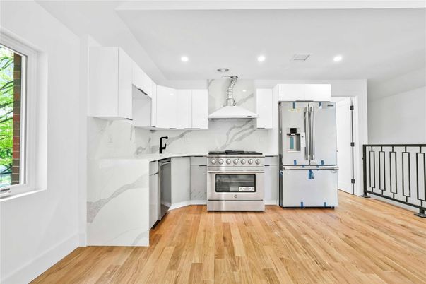 Interior, Kitchen, Marble Walls, Recessed Lighting, Stainless Steel Appliances, Wood Texture Flooring