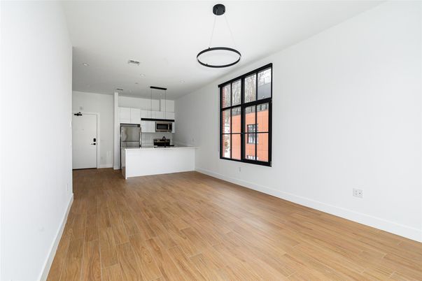 Empty room, Interior, Kitchen, Pendant Lights, Recessed Lighting, Stainless Steel Appliances, Wood Texture Flooring