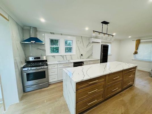 Chandelier, Interior, Kitchen, Marble Walls, Pendant Lights, Recessed Lighting, Stainless Steel Appliances, Wood Texture Flooring