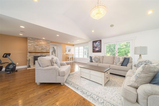 Fireplace, Fitness Equipment, Interior, Living room, Recessed Lighting, Stone Walls, Wood Texture Flooring
