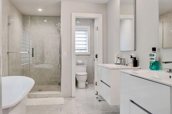 Bathroom, Dual Sink Vanities, Glass Shower, Interior, Marble, Marble Walls, Recessed Lighting
