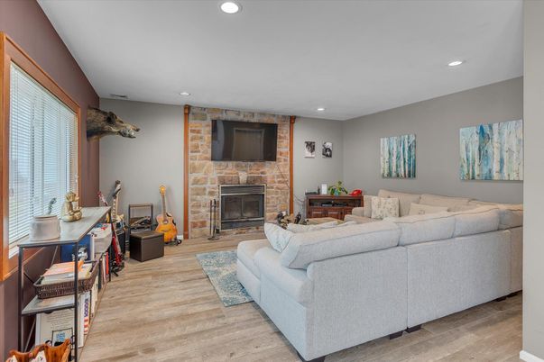 Fireplace, Interior, Living room, Recessed Lighting, Stone Walls, Wood Texture Flooring