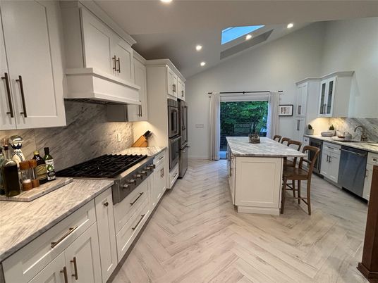 Interior, Kitchen, Marble Walls, Recessed Lighting, Stainless Steel Appliances, Wood Texture Flooring