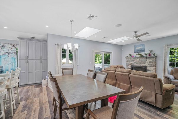 Dining room, Fireplace, Interior, Living room, Pendant Lights, Recessed Lighting, Wood Texture Flooring