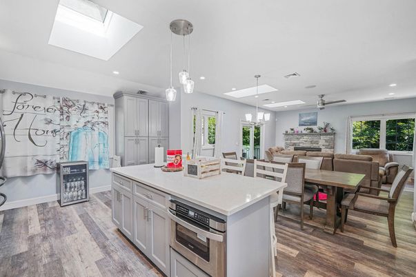 Dining room, Fireplace, Interior, Kitchen, Living room, Pendant Lights, Recessed Lighting, Stainless Steel Appliances, Wood Texture Flooring