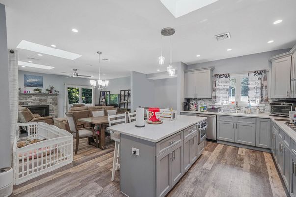 Chandelier, Dining room, Fireplace, Interior, Kitchen, Pendant Lights, Recessed Lighting, Stainless Steel Appliances, Wood Texture Flooring