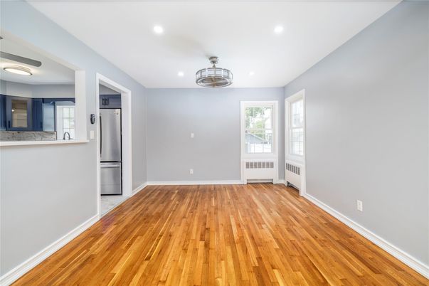 Empty room, Interior, Kitchen, Recessed Lighting, Stainless Steel Appliances, Wood Texture Flooring