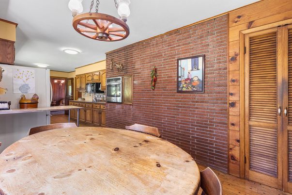 Dining room, Interior, Kitchen, Pendant Lights, Recessed Lighting, Stainless Steel Appliances, Stone Walls, Wood Texture Flooring