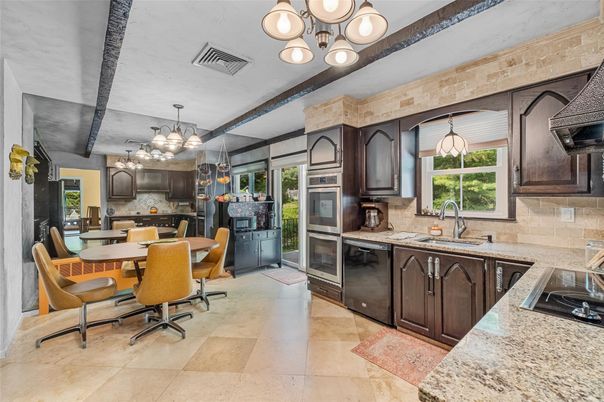 Chandelier, Dining room, Interior, Kitchen, Pendant Lights, Stainless Steel Appliances, Stone Walls
