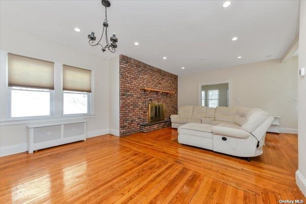 Chandelier, Fireplace, Interior, Living room, Recessed Lighting, Stone Walls, Wood Texture Flooring