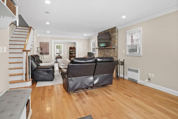 Fireplace, Interior, Living room, Recessed Lighting, Stone Walls, Wood Texture Flooring