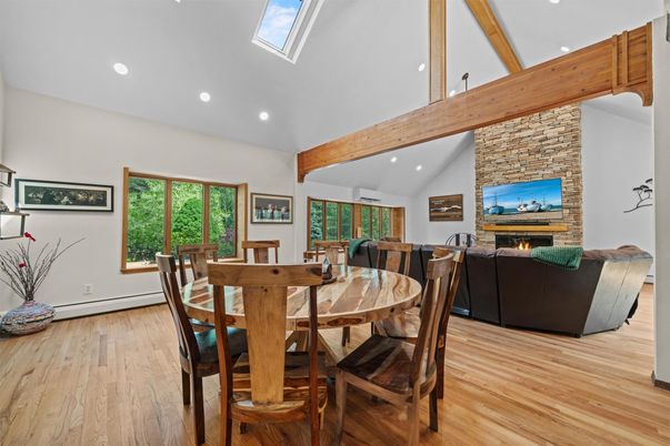 Dining room, Fireplace, Interior, Living room, Recessed Lighting, Stone Walls, Wooden Beams, Wood Texture Flooring
