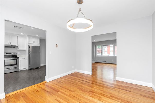 Empty room, Interior, Kitchen, Pendant Lights, Recessed Lighting, Stainless Steel Appliances, Wood Texture Flooring