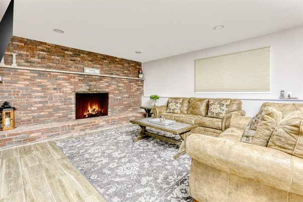 Fireplace, Interior, Living room, Recessed Lighting, Stone Walls, Wood Texture Flooring