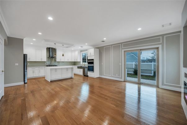 Empty room, Interior, Kitchen, Pendant Lights, Recessed Lighting, Stainless Steel Appliances, Wood Texture Flooring