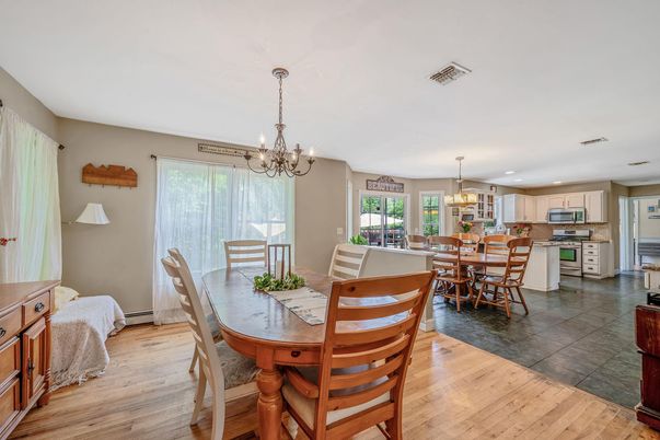 Chandelier, Dining room, Interior, Kitchen, Pendant Lights, Recessed Lighting, Stainless Steel Appliances, Wood Texture Flooring