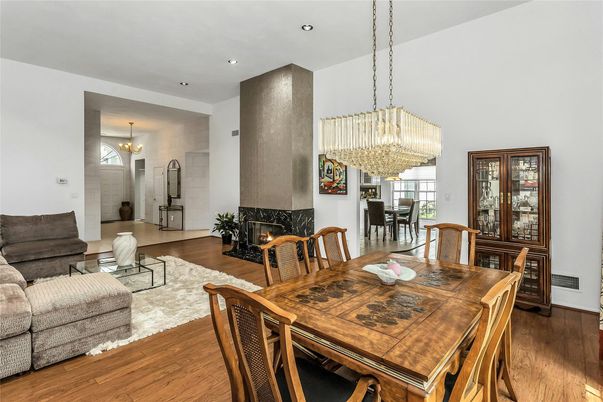 Chandelier, Dining room, Fireplace, Interior, Living room, Pendant Lights, Recessed Lighting, Wood Texture Flooring