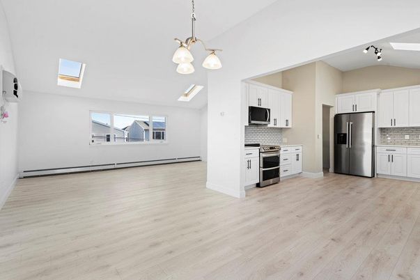 Empty room, Interior, Kitchen, Pendant Lights, Stainless Steel Appliances, Wood Texture Flooring