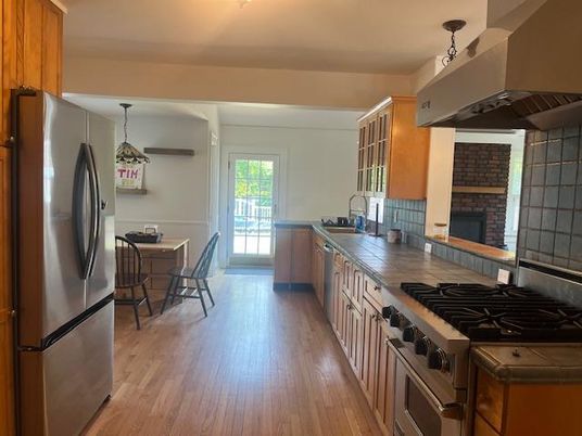 Dining room, Fireplace, Interior, Kitchen, Pendant Lights, Stainless Steel Appliances, Wood Texture Flooring