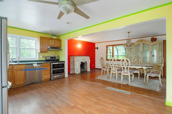Chandelier, Dining room, Fireplace, Interior, Kitchen, Recessed Lighting, Stainless Steel Appliances, Wood Texture Flooring