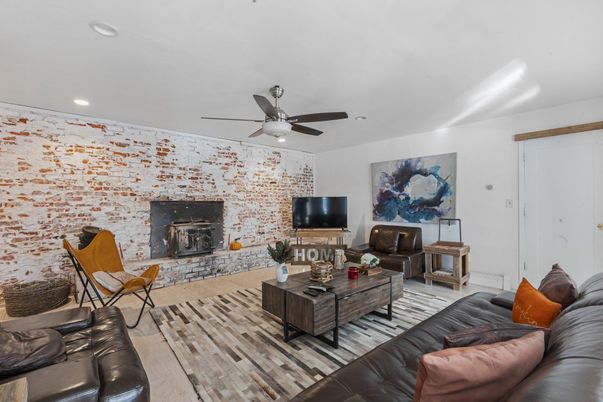 Fireplace, Interior, Living room, Recessed Lighting, Stone Walls, Wood Texture Flooring