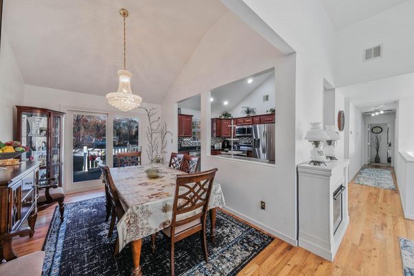Chandelier, Dining room, Interior, Kitchen, Pendant Lights, Recessed Lighting, Stainless Steel Appliances, Wood Texture Flooring