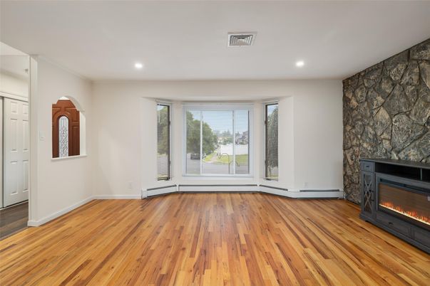 Empty room, Fireplace, Interior, Recessed Lighting, Stone Walls, Wood Texture Flooring