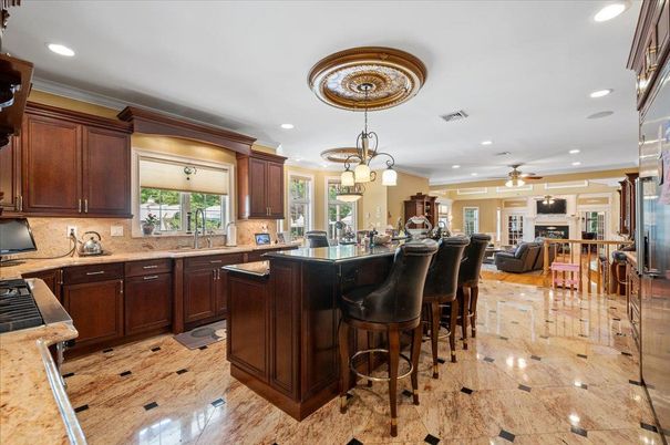 Chandelier, Fireplace, Interior, Kitchen, Living room, Pendant Lights, Recessed Lighting, Wood Texture Flooring