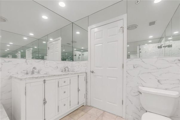 Bathroom, Dual Sink Vanities, Glass Shower, Interior, Marble, Marble Walls, Recessed Lighting