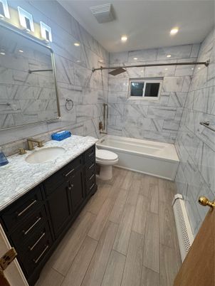 Bathroom, Dual Sink Vanities, Interior, Marble Walls, Recessed Lighting, Wood Texture Flooring