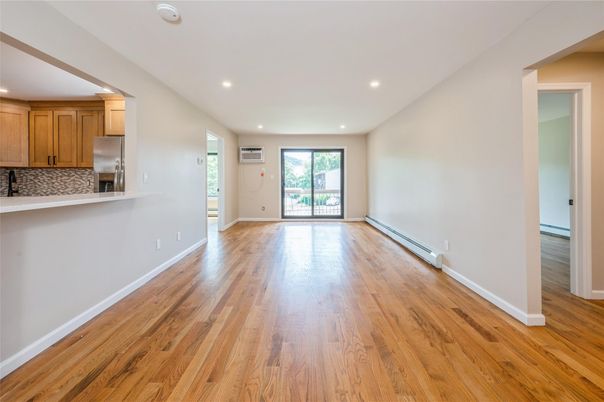 Empty room, Interior, Kitchen, Recessed Lighting, Stainless Steel Appliances, Wood Texture Flooring