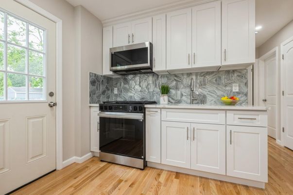 Interior, Kitchen, Marble Walls, Recessed Lighting, Stainless Steel Appliances, Wood Texture Flooring