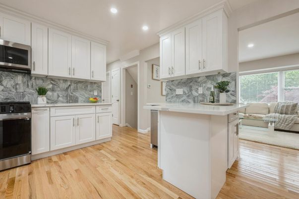 Interior, Kitchen, Marble Walls, Recessed Lighting, Stainless Steel Appliances, Wood Texture Flooring