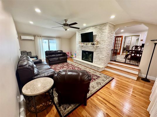 Dining room, Fireplace, Interior, Living room, Recessed Lighting, Stone Walls, Wood Texture Flooring