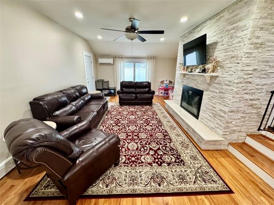 Fireplace, Interior, Living room, Recessed Lighting, Stone Walls, Wood Texture Flooring