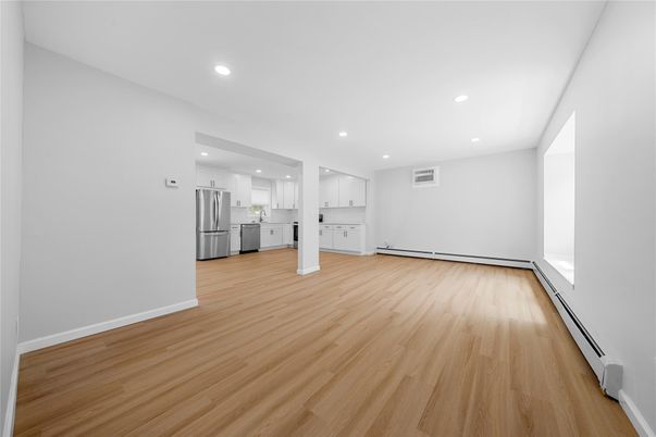 Empty room, Interior, Kitchen, Recessed Lighting, Stainless Steel Appliances, Wood Texture Flooring