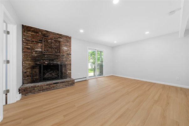 Empty room, Fireplace, Interior, Recessed Lighting, Stone Walls, Wood Texture Flooring