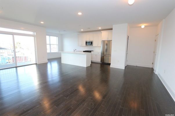 Empty room, Interior, Kitchen, Recessed Lighting, Stainless Steel Appliances, Wood Texture Flooring