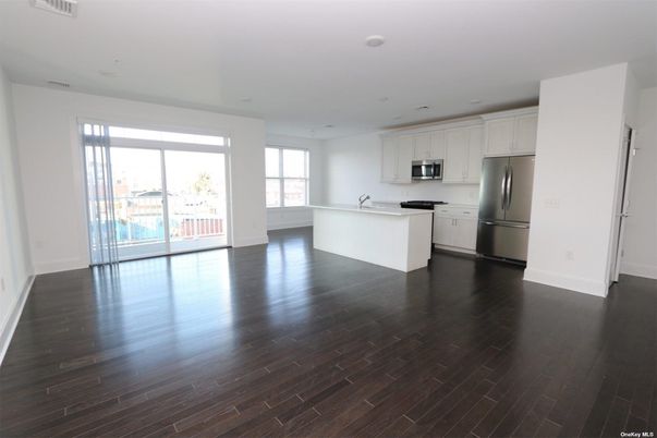 Empty room, Interior, Kitchen, Recessed Lighting, Stainless Steel Appliances, Wood Texture Flooring