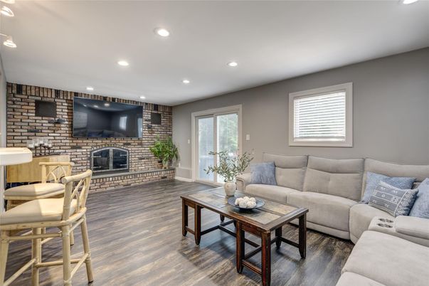 Fireplace, Interior, Living room, Recessed Lighting, Stone Walls, Wood Texture Flooring