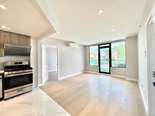 Empty room, Interior, Kitchen, Marble, Recessed Lighting, Stainless Steel Appliances, Wood Texture Flooring