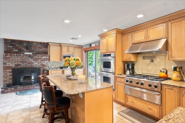 Fireplace, Interior, Kitchen, Recessed Lighting, Stainless Steel Appliances, Stone Walls